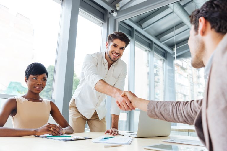 new partners agreeing to do business together shaking hands